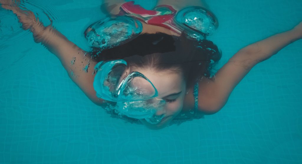 woman swimming under water