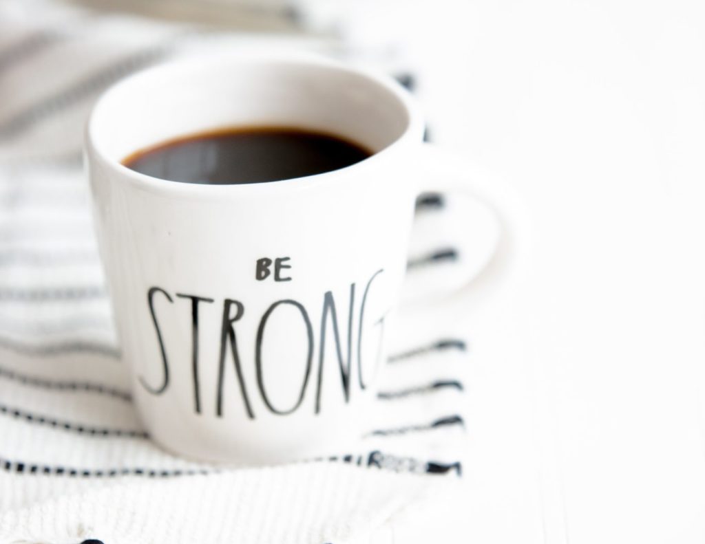 white ceramic mug filled with black coffee