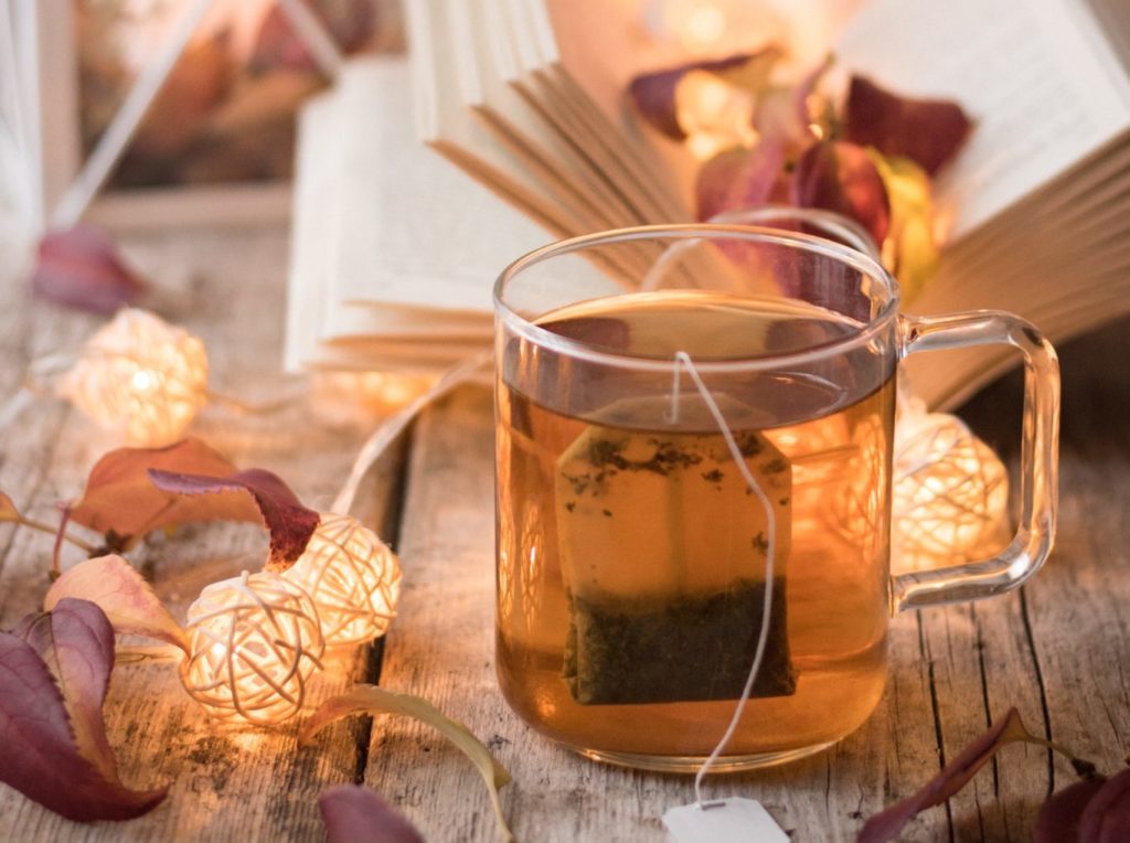 clear glass mug with brown liquid inside