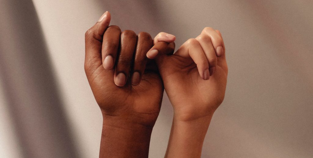 persons hand with white manicure