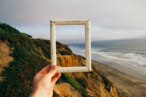 person hand holding photo frame