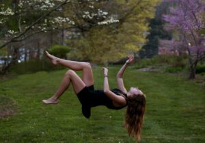 woman back flipping in the garden