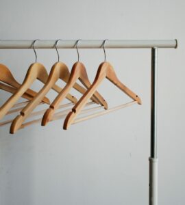 four brown wooden clothes hangers