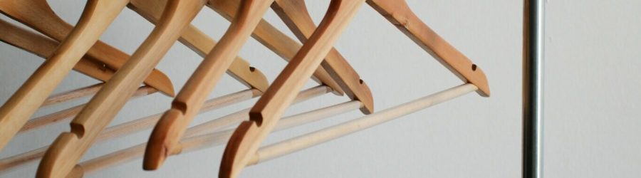 four brown wooden clothes hangers