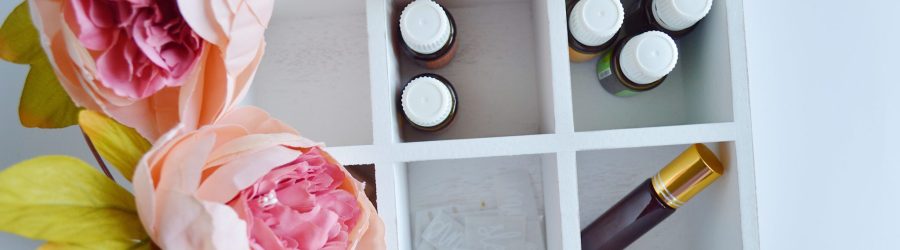 several vials in white wooden organizer shelf