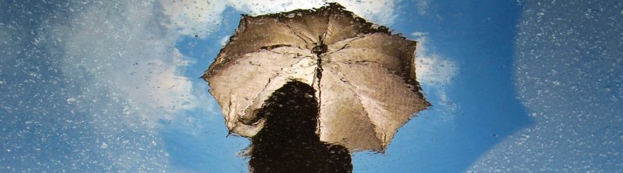 person standing on gray surface while holding umbrella