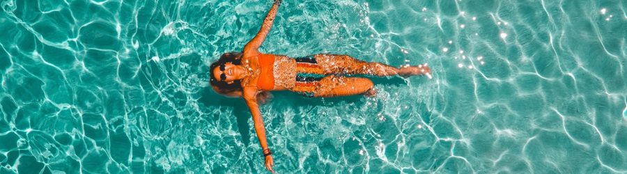 woman swimming alone in body of water