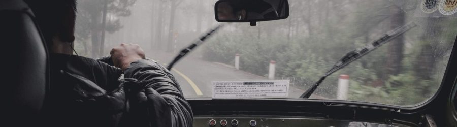 man driving car during rainy daytime