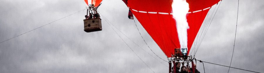 people on red and beige air balloons